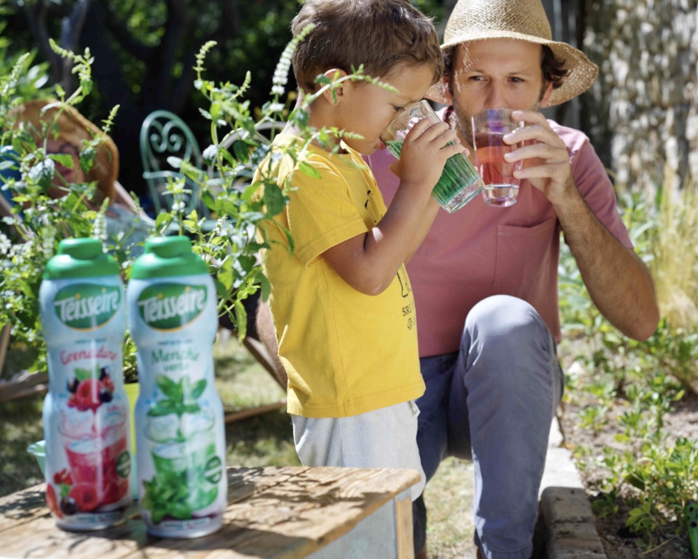 father and son drinking juice